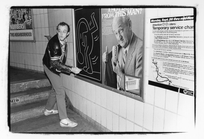 Keith Haring drawing on a subway platform in New York City, circa 1985.