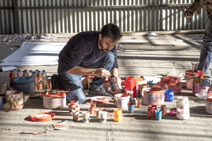 Photo of Mehdi Ghadyanloo working in his Tehran studio on his recent commission for the the World Economic Forum 2019 Annual Meeting in Davos