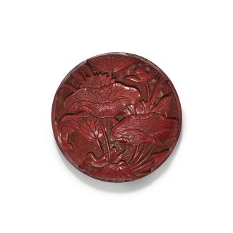 View 1 of Lot 31: A carved cinnabar lacquer 'lotus' box and cover, Ming dynasty, 16th century | 明十六世紀 剔紅荷塘紋印盒