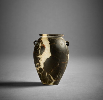 View 1 of Lot 358: An Egyptian Breccia Lug Handle Jar, Predynastic Period, circa 3500-3000 B.C.