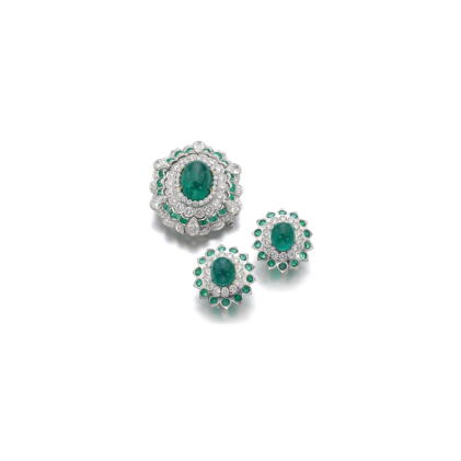 Catalog image of emerald and diamond brooch and a pair of ear clips