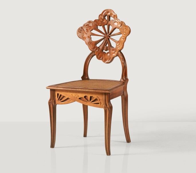 Émile Gallé, La Berce des Prés or Ombelles chair, circa 1902. Carved walnut and cane, Signed Gallé on one leg. Estimate €8,000-12,000.